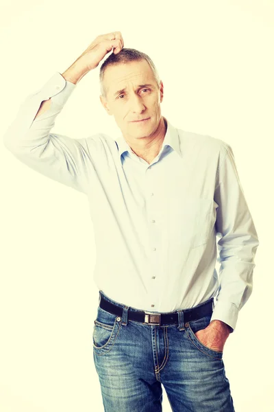 Confused man scratching his head Royalty Free Stock Images