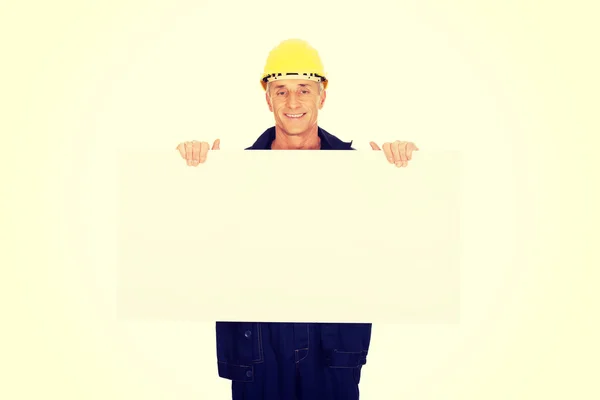 Worker presenting empty banner — Stock Photo, Image