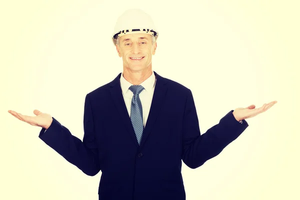 Businessman with hard hat holding copy space — Stock Photo, Image