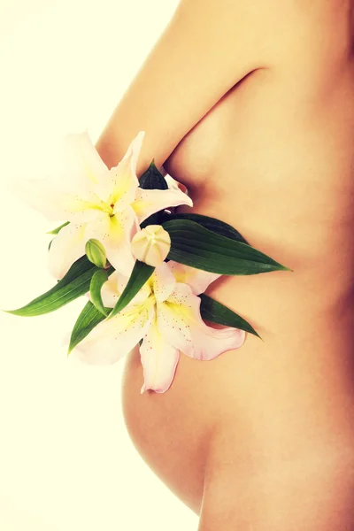 Pregnant woman holding a lily flower — Stock Photo, Image