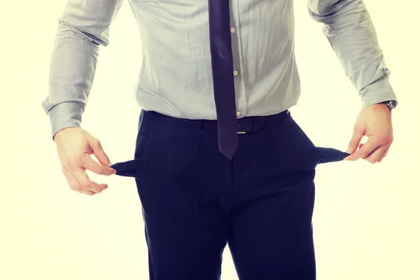 Businessman showing empty pockets — Stock Photo, Image