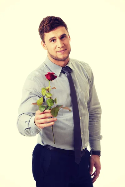 Handsome man holding red rose. — Stock Photo, Image