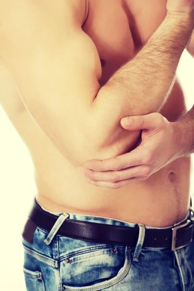 Athletic man feeling pain in his elbow. — Stock Photo, Image