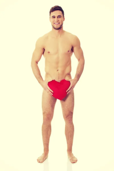 Nude man covering his self with heart. — Stock Photo, Image