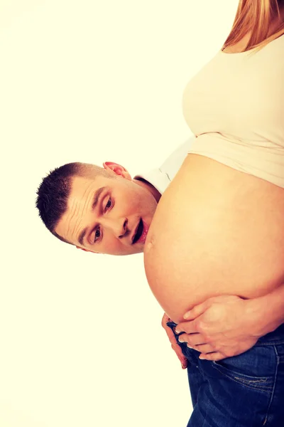 Father talking to mother's pregnant tummy — Stock Photo, Image