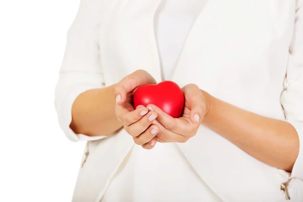 Woman holding heart shaped toy — Stock Photo, Image