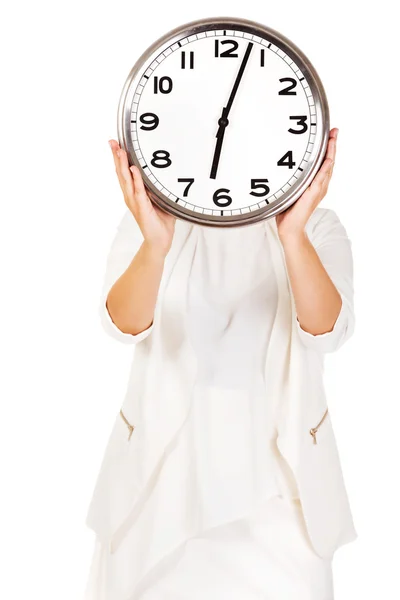 Businesswoman covering face with clock — Stock Photo, Image