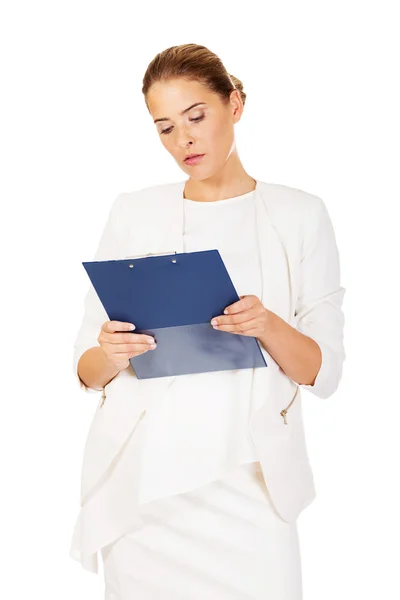 Thoughtful focused businesswoman reading her notes — Stock Photo, Image