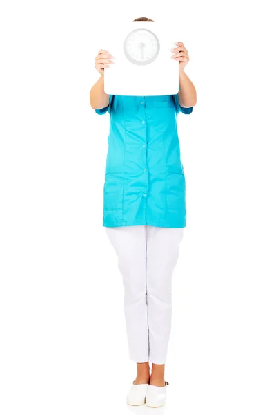 Young doctor or nurse holding weight — Stock Photo, Image