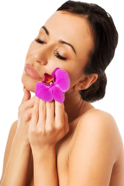 Woman with purple orchid and closed eyes — Stock Photo, Image