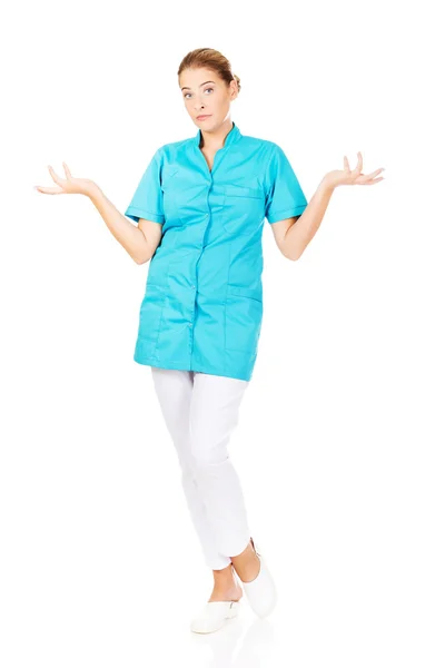 Young female doctor or nurse shrugs Stock Image