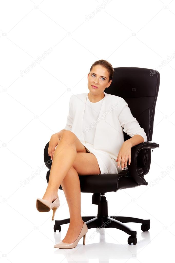 Tired businesswoman sitting on armchair