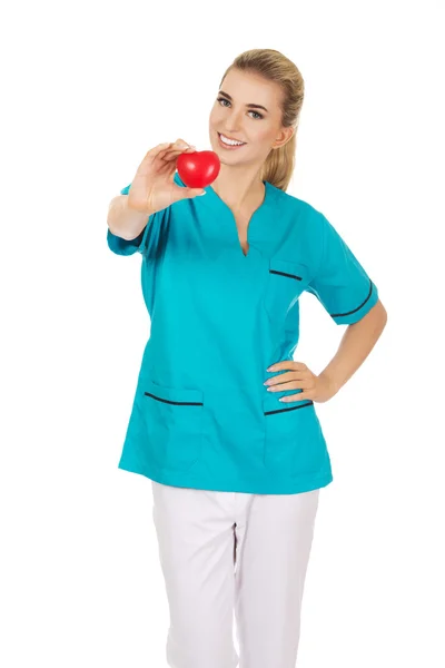 Enfermeira sorridente ou médico com coração — Fotografia de Stock
