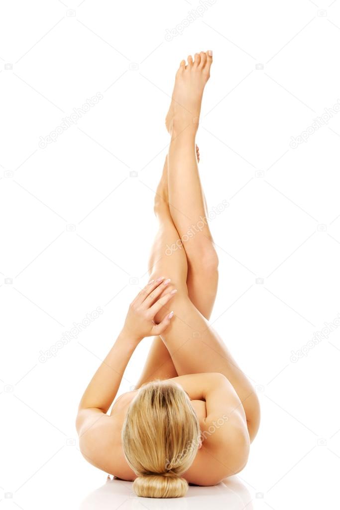 Young naked woman with legs up.