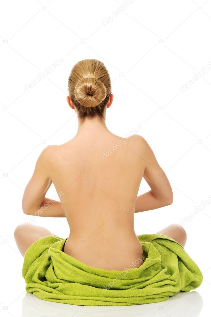 Young woman sitting in a yoga position