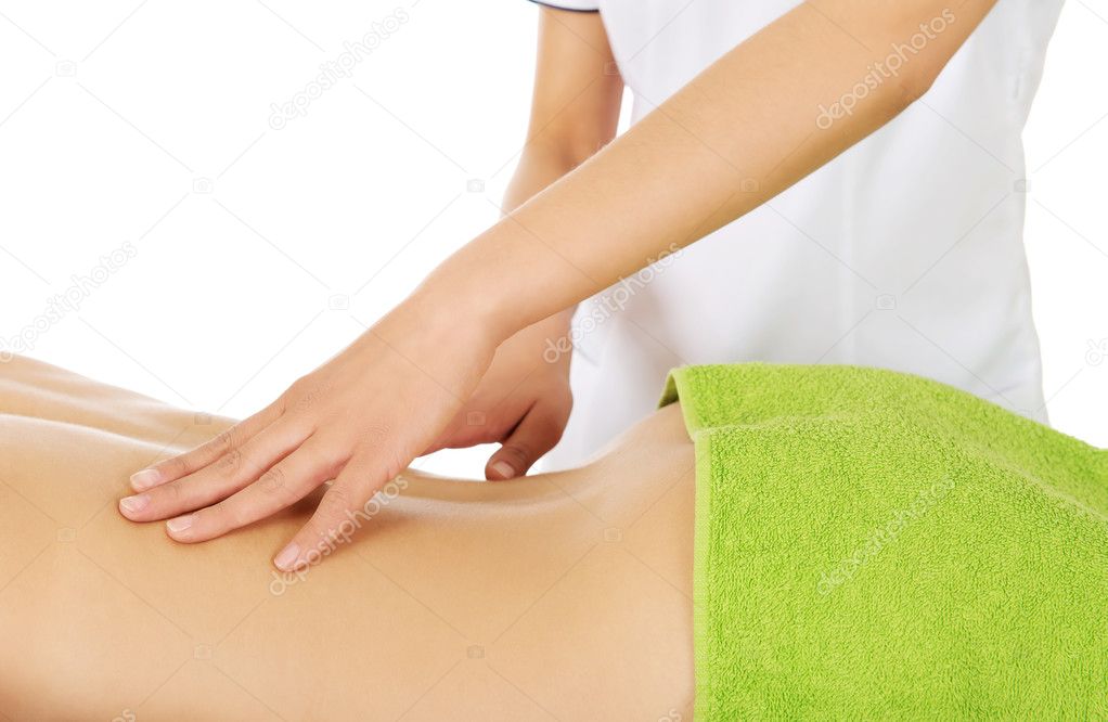 Young woman is being massaged.