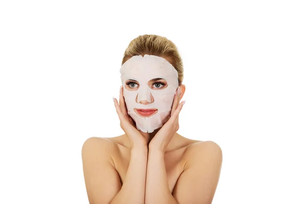 Young woman with facial mask — Stock Photo, Image