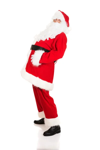 Santa Claus greppa hans mage — Stockfoto