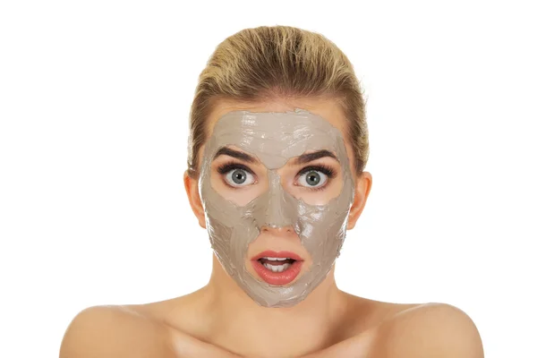 Surprised woman with facial mask — Stock Photo, Image