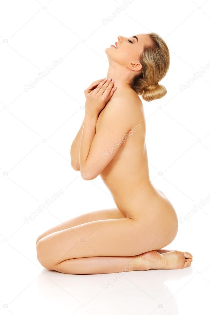 Naked woman sitting on the floor