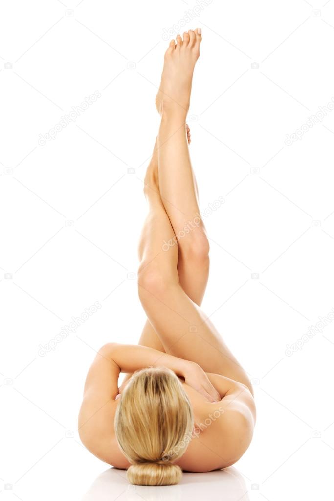 Young naked woman with legs up.