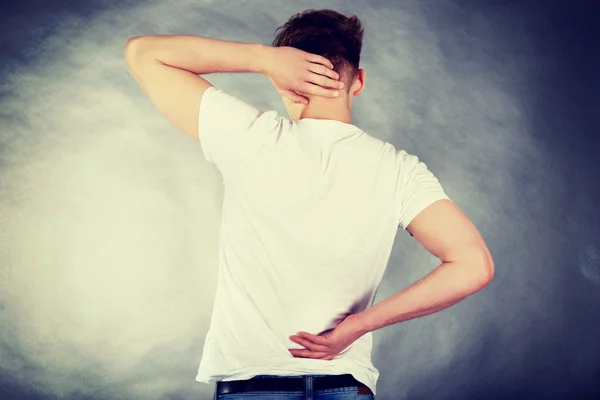 Young man holding his neck in pain. — Stock Photo, Image