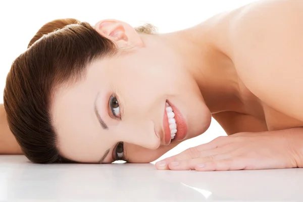 Naked woman lying on belly Stock Image