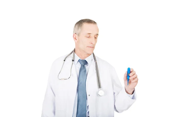 Mature male doctor holding a thermometer — Stock Photo, Image