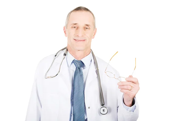 Mature male doctor holding his eyewear — Stock Photo, Image