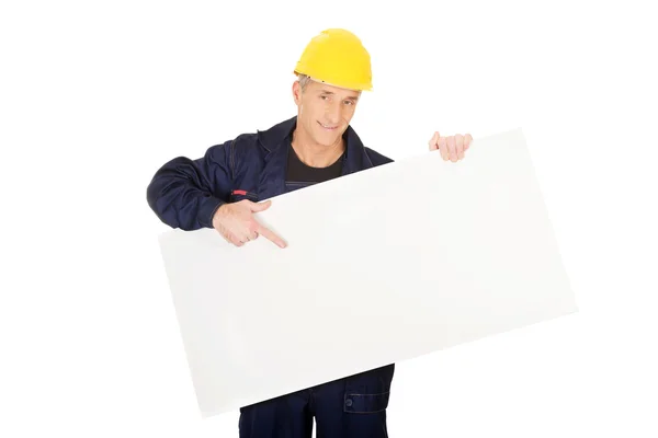 Happy worker presenting empty banner — Stock Photo, Image