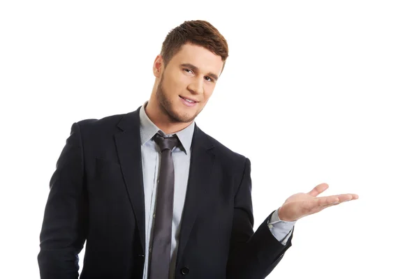 Handsome businessman holding copy space — Stock Photo, Image