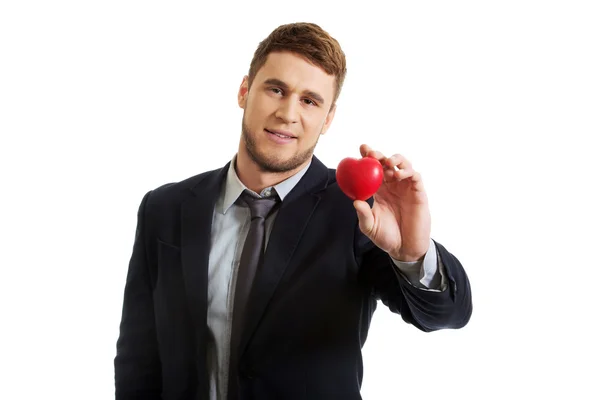 Businessman with heart model. — Stock Photo, Image