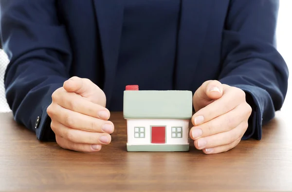 Businesswoman presenting a model house Stock Image