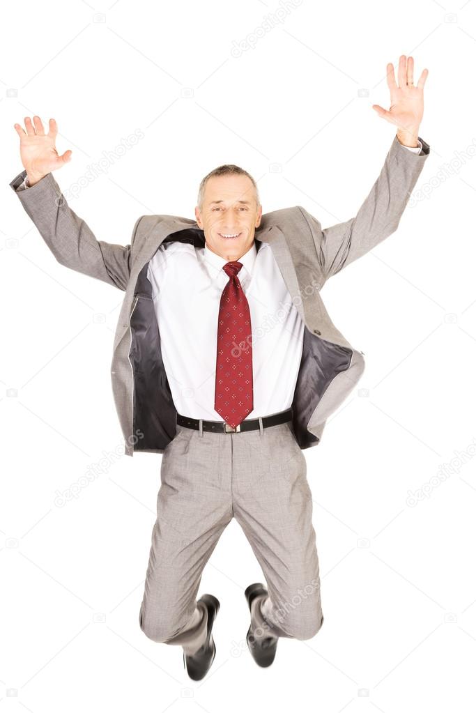 Excited businessman jumping because of success