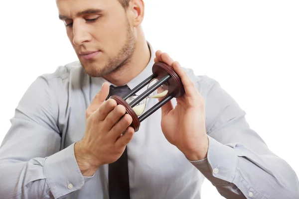 Businessman holding hourglass. — Stock Photo, Image