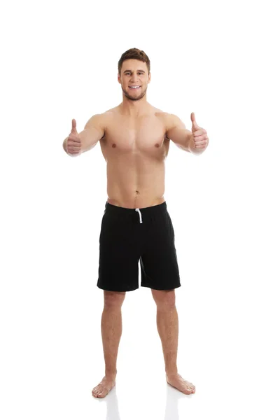 Sexy muscular man showing thumbs up. — Stock Photo, Image