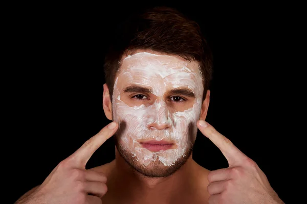 Man with cream moisturizer on his face. — Stock Photo, Image