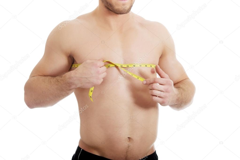 Muscular man measuring his chest. Stock Photo by ©piotr_marcinski
