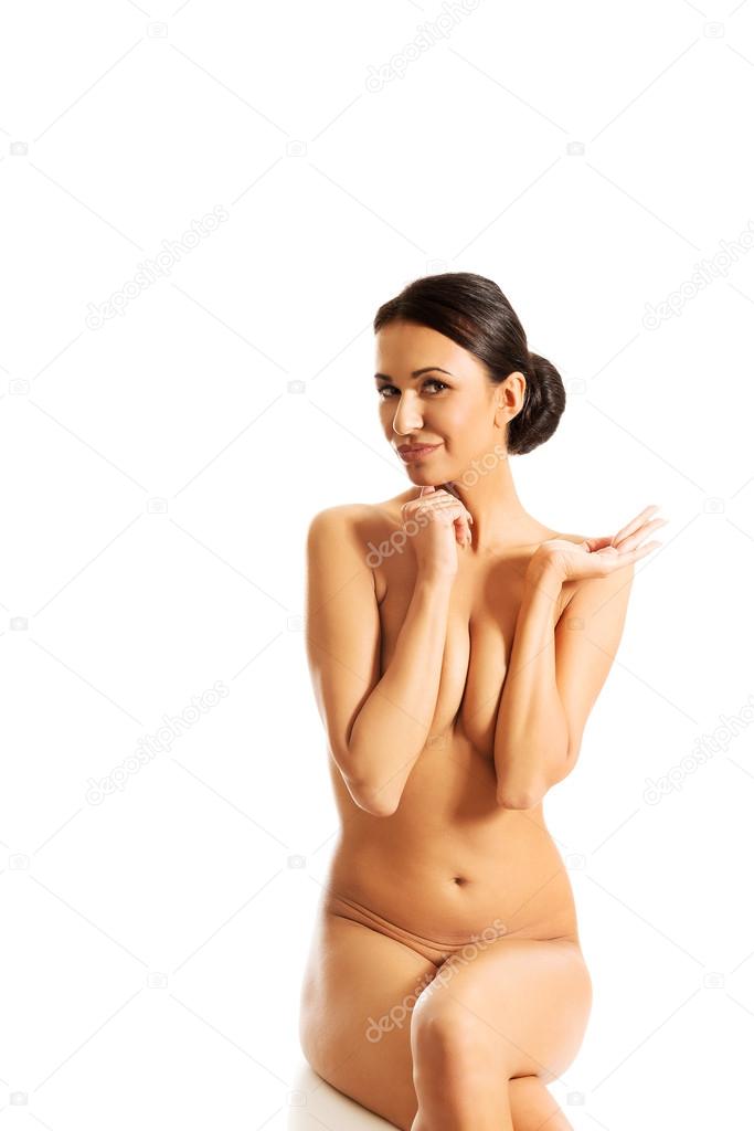 Nude woman sitting on desk