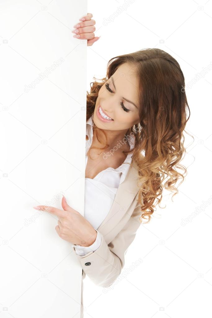 Business woman pointing on empty banner.