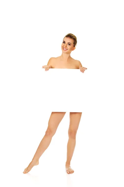 Naked woman holding empty board. — Stock Photo, Image