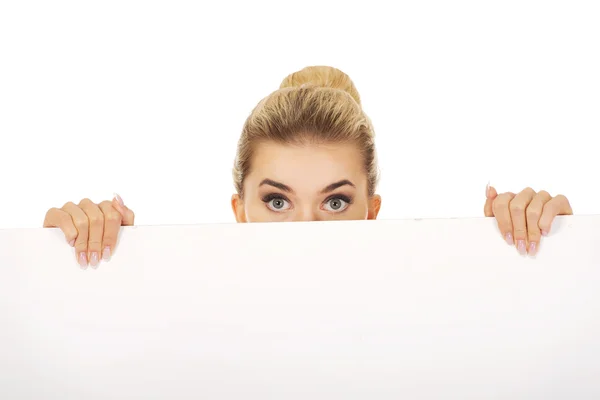 Businesswoman holding empty billboard — Stock Photo, Image