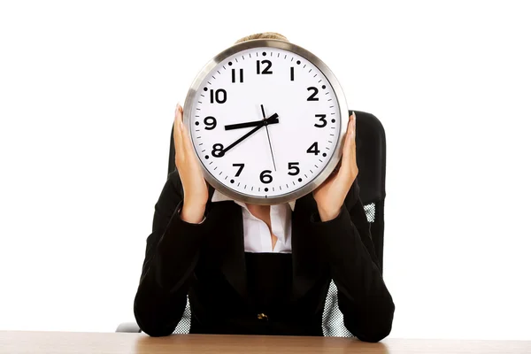 Businesswoman hidden behind the clock — Stock Photo, Image