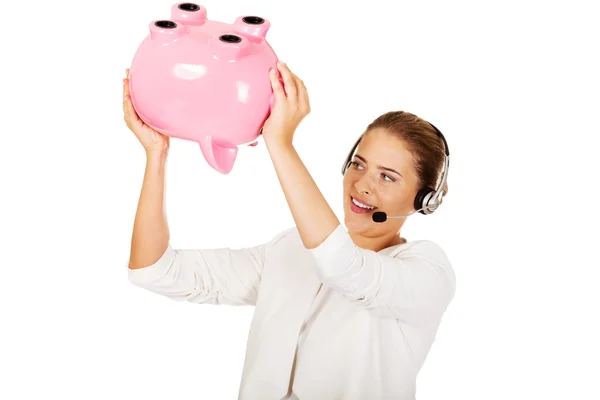 ヘッドセット piggybank を保持の若い女性実業家 — ストック写真