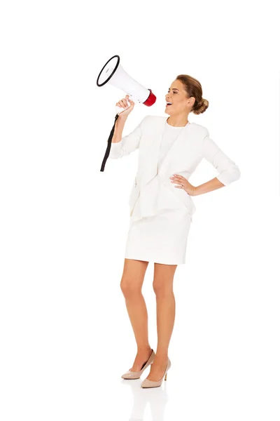 Beautiful businesswoman screaming through megaphone — Stock Photo, Image