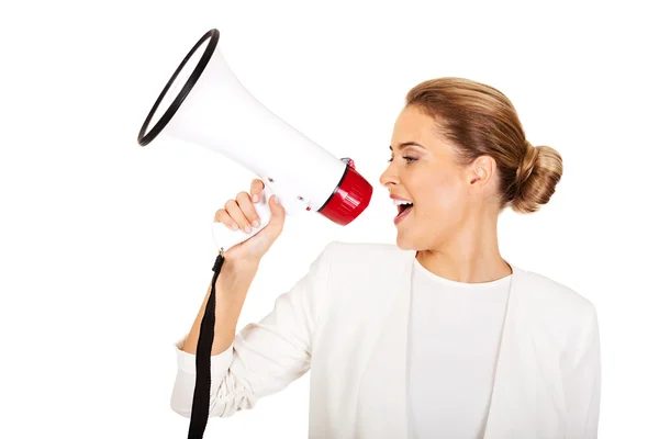 Beautiful businesswoman screaming through megaphone — Stock Photo, Image