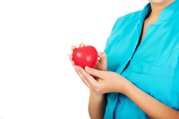 Junge Ärztin oder Krankenschwester mit Herzspielzeug — Stockfoto