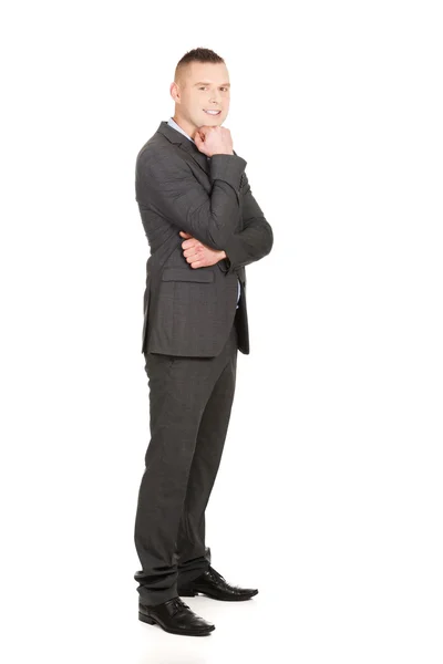 Businessman with hand under chin — Stock Photo, Image