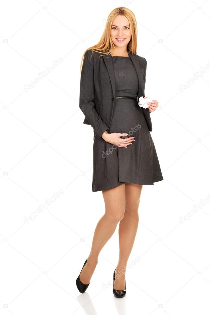 Pregnant businesswoman holding plane model