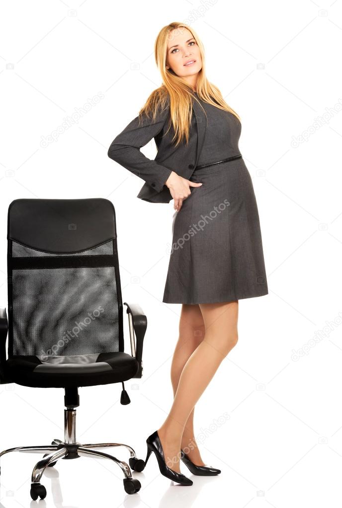 Pregnant businesswoman with back pain